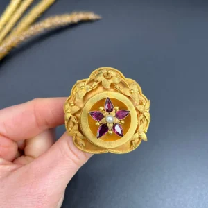 Victorian floral brooch with gemstones in gold.