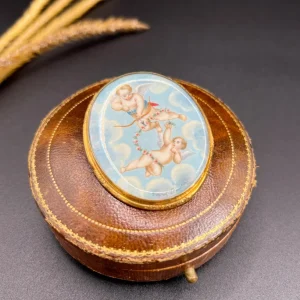 Antique cupid brooch in gold with mother-of-pearl back.