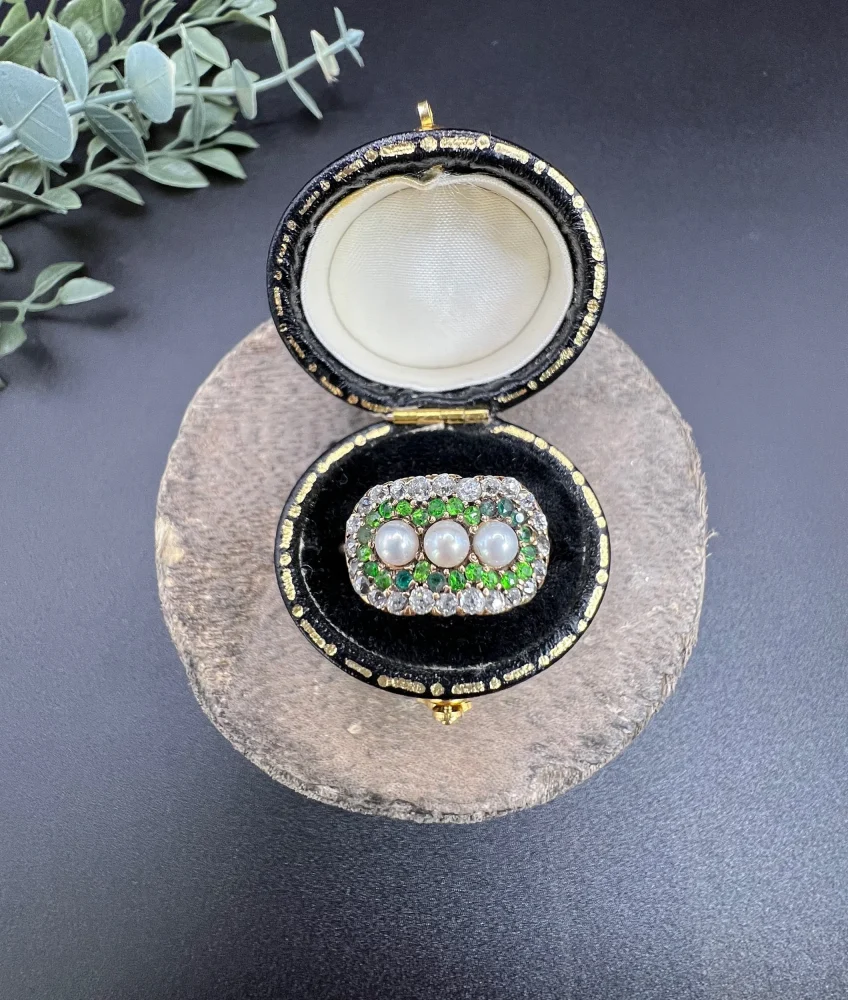 Antique trilogy cluster ring with gemstones in gold.