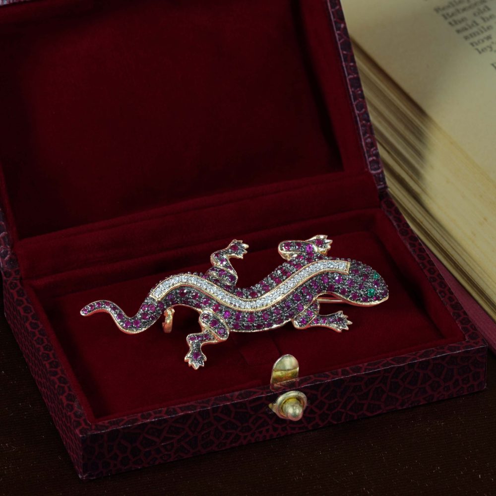 Ruby and Diamond Lizard Brooch with Emerald Eyes in 14ct Gold, body covered in deep red rubies with central line of sparkling diamonds and bright green emerald eyes