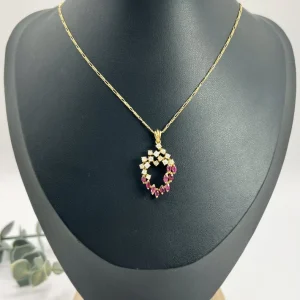 Vintage ruby and diamond heart pendant and chain in gold.