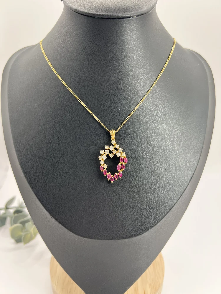 Vintage ruby and diamond heart pendant and chain in gold.