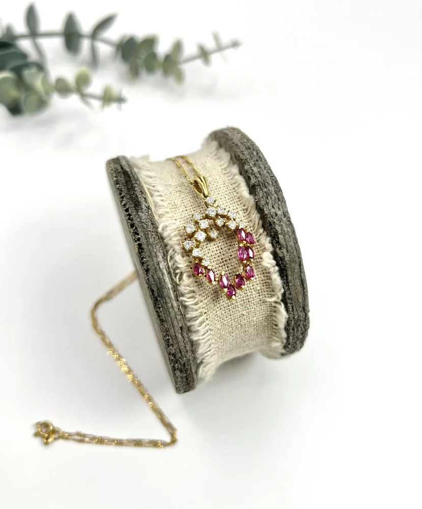 Vintage ruby and diamond heart pendant and chain in gold.