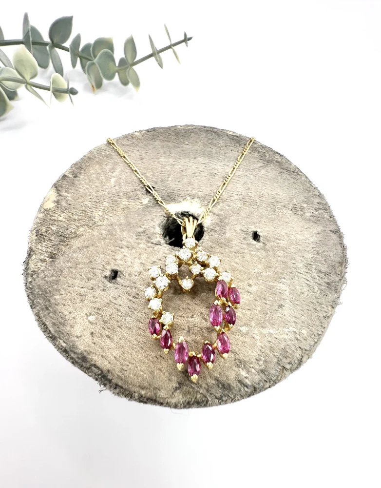 Vintage ruby and diamond heart pendant and chain in gold.