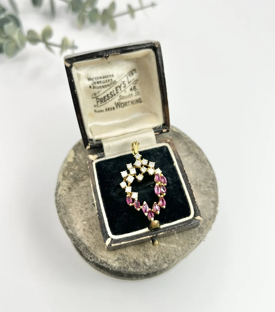 Vintage ruby and diamond heart pendant and chain in gold.