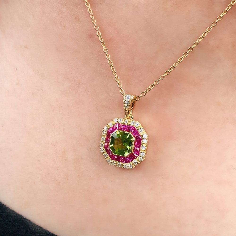 Peridot Ruby and Diamond Octagonal Target Cluster Pendant in 18ct Yellow Gold, octagonal-shaped Asscher-cut green peridot surrounded by pinkish-red rubies with outer border of sparkling diamonds