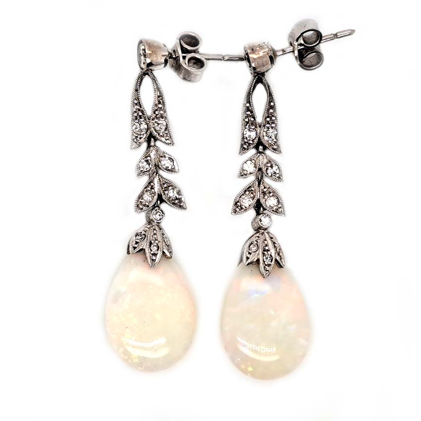 Edwardian Antique Opal and Diamond Drop Earrings, Diamond tops suspend floral diamond leaf designs with trefoil diamond caps holding pear drop opals