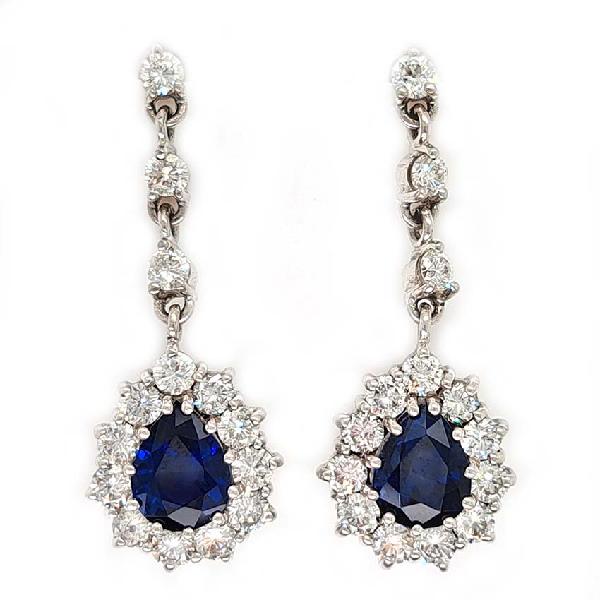 Vintage Pear Cut Royal Blue Sapphire and Diamond Cluster Drop Earrings in 18ct White Gold, teardrop pear-shaped Royal blue sapphires with brilliant-cut diamond borders suspended from a row of three diamonds Circa 1960s
