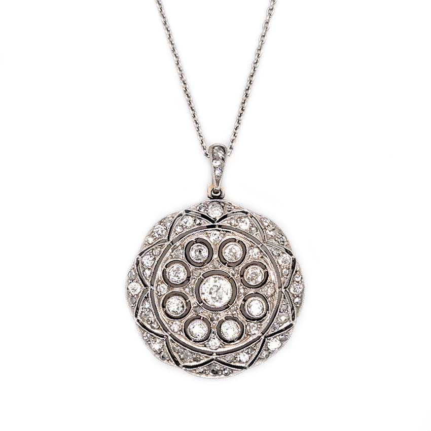 Belle Epoque Antique Old Cut Diamond Circular Pendant, set with 0.90cts sparkling old European transitional cut and rose cut diamonds in openwork platinum. French, Circa 1908