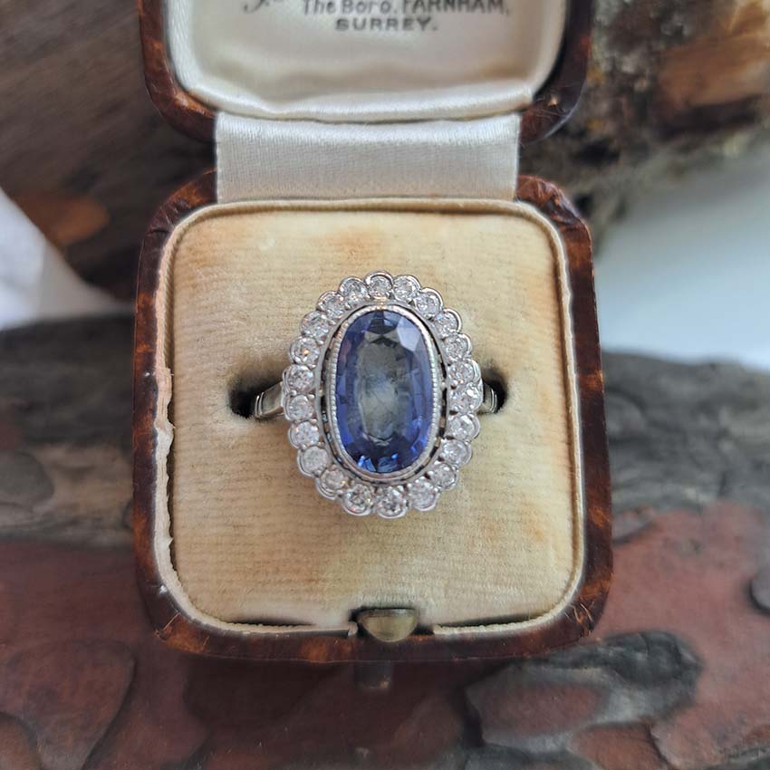 2.10ct Oval Sapphire and Diamond Cluster Ring in Platinum, 2.10 carat oval sapphire surrounded by 0.60 carats of sparkling round brilliant-cut diamonds