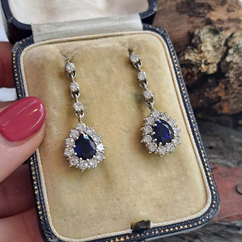 Vintage Pear Cut Royal Blue Sapphire and Diamond Cluster Drop Earrings in 18ct White Gold, teardrop pear-shaped Royal blue sapphires with brilliant-cut diamond borders suspended from a row of three diamonds Circa 1960s