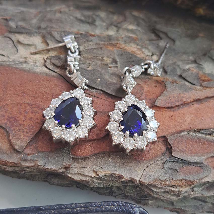 Vintage Pear Cut Royal Blue Sapphire and Diamond Cluster Drop Earrings in 18ct White Gold, teardrop pear-shaped Royal blue sapphires with brilliant-cut diamond borders suspended from a row of three diamonds Circa 1960s