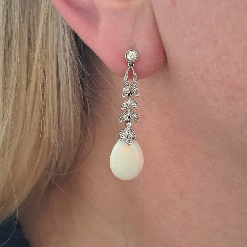 Edwardian Antique Opal and Diamond Drop Earrings, Diamond tops suspend floral diamond leaf designs with trefoil diamond caps holding pear drop opals