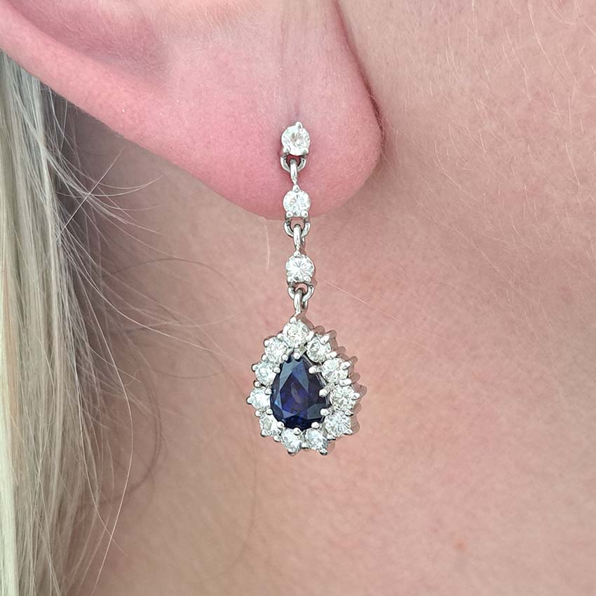 Vintage Pear Cut Royal Blue Sapphire and Diamond Cluster Drop Earrings in 18ct White Gold, teardrop pear-shaped Royal blue sapphires with brilliant-cut diamond borders suspended from a row of three diamonds Circa 1960s