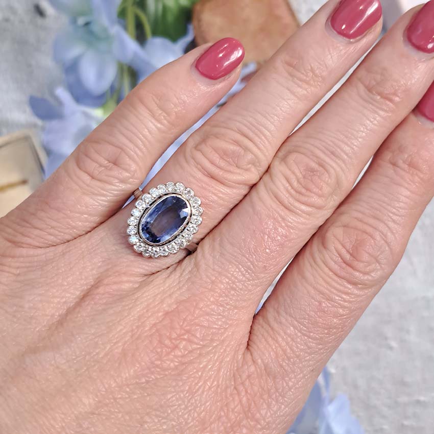 2.10ct Oval Sapphire and Diamond Cluster Ring in Platinum, 2.10 carat oval sapphire surrounded by 0.60 carats of sparkling round brilliant-cut diamonds