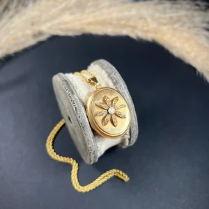 Antique gold locket with pearl flower.