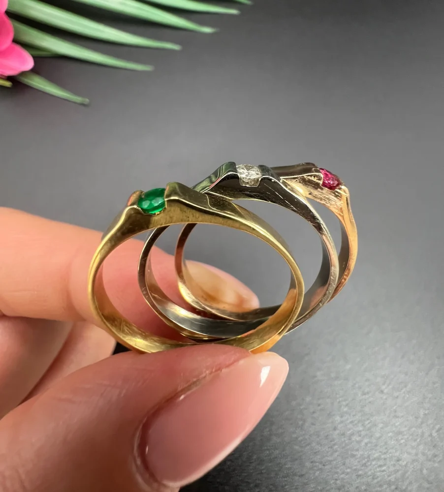 Gold stacking ring with emerald diamond and ruby.