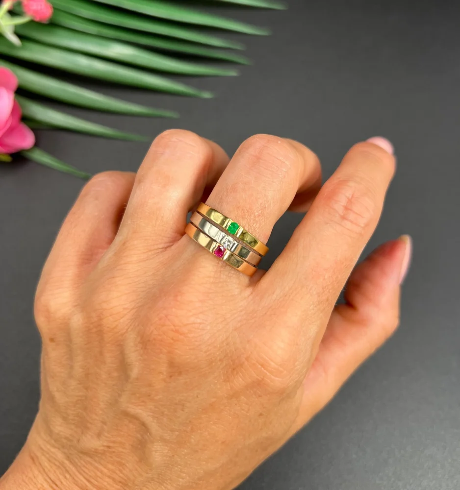 Gold stacking ring with emerald diamond and ruby.