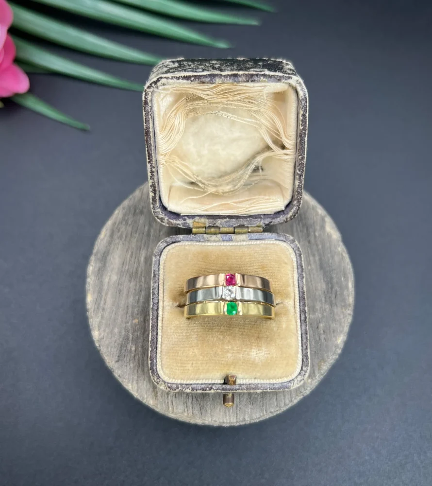 Gold stacking ring with emerald diamond and ruby.