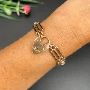 Gold gate bracelet with moonstones and heart padlock.