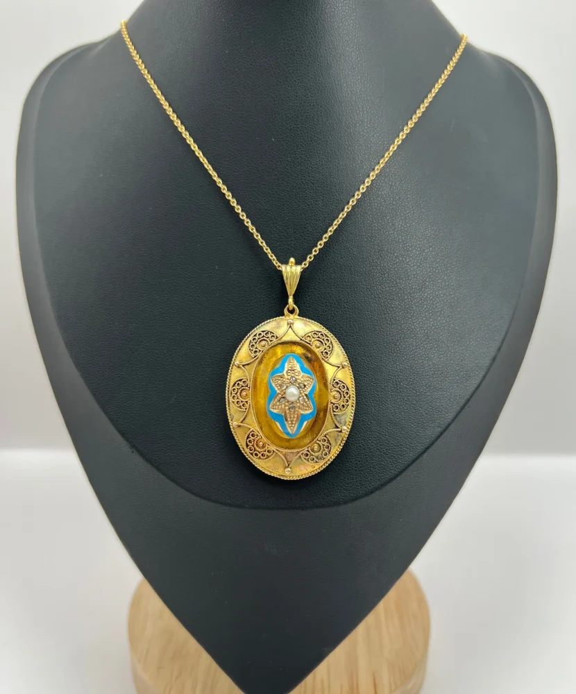 Antique gold locket/pendant with enamel and gemstones.