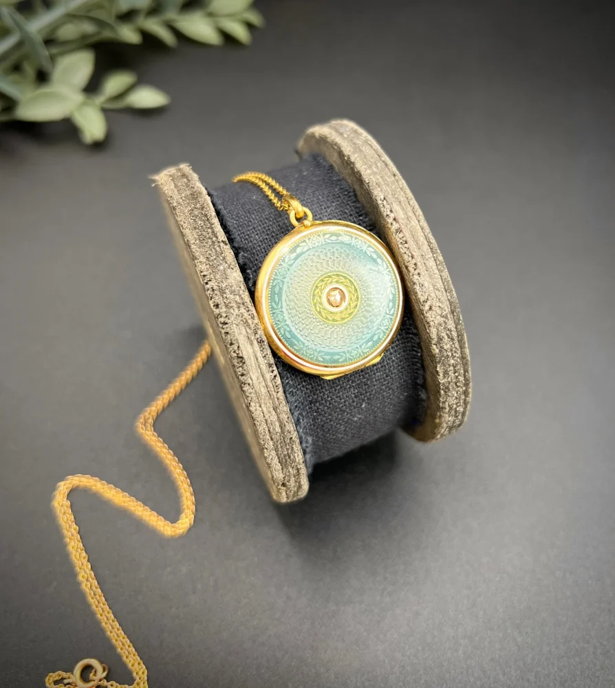 Edwardian enamel and diamond locket in gold.