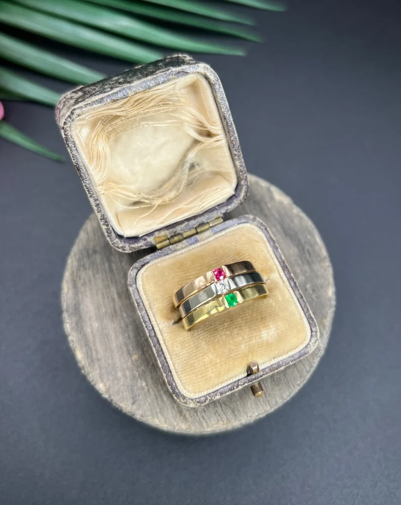 Gold stacking ring with emerald diamond and ruby.