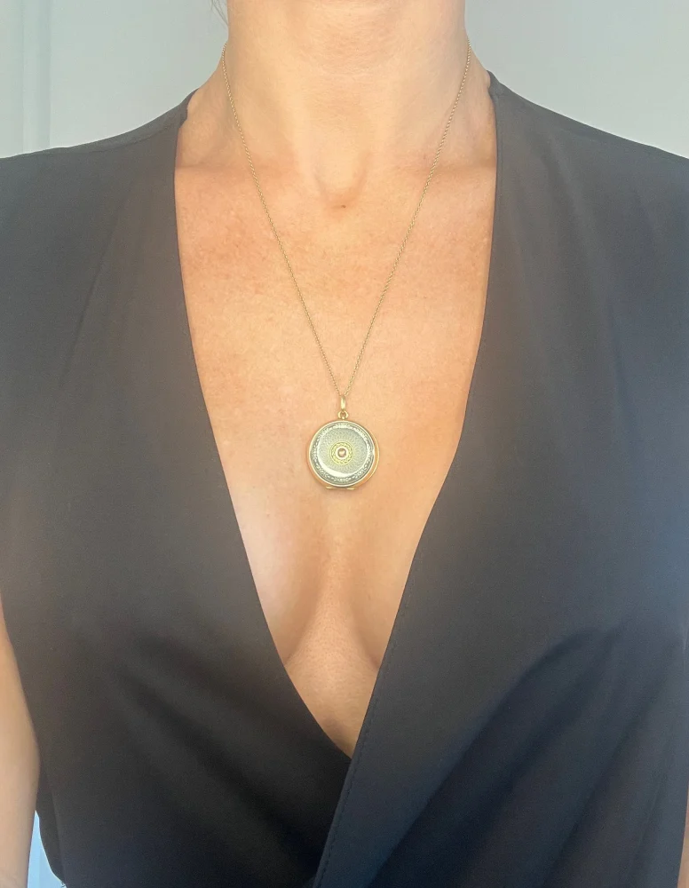 Edwardian enamel and diamond locket in gold.