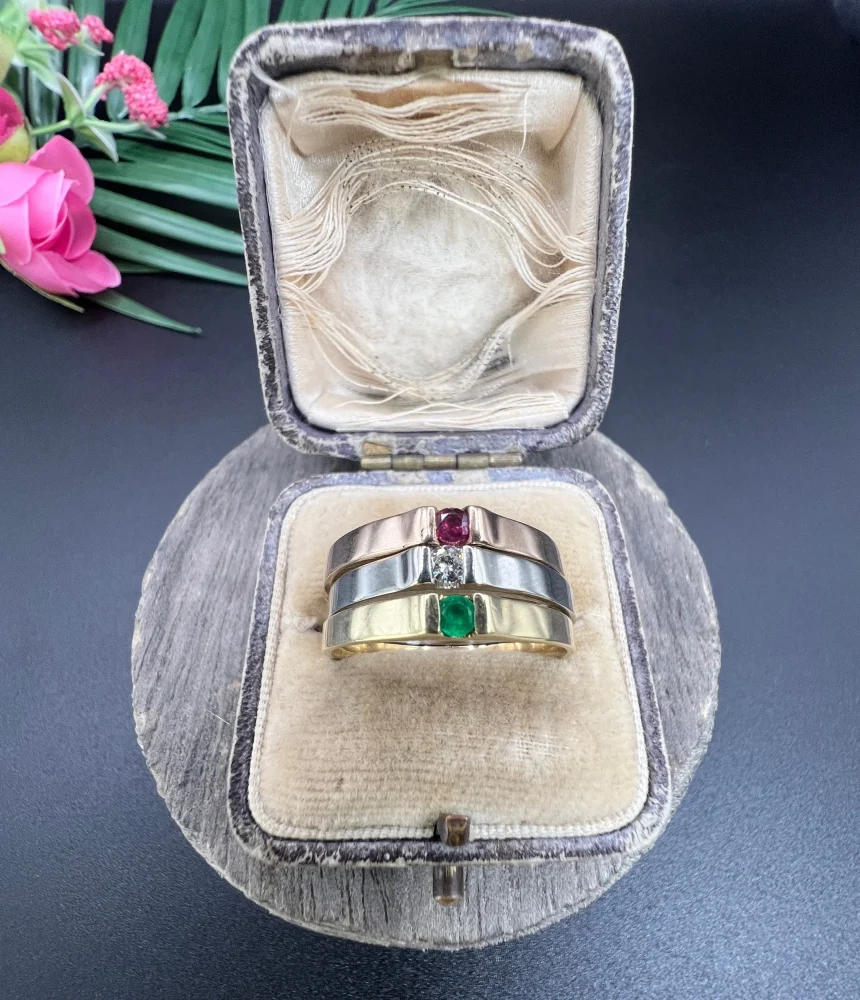 Gold stacking ring with emerald diamond and ruby.
