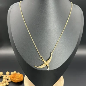 Antique gold swallow pendant with pearls and diamond.