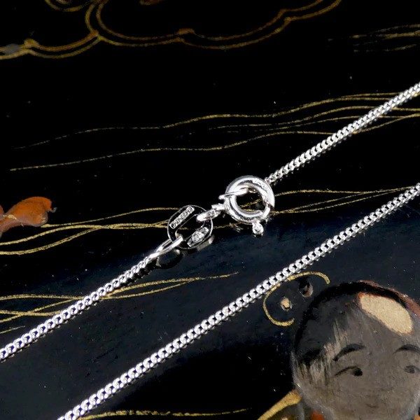 Diamond heart shaped pendant necklace in white gold.