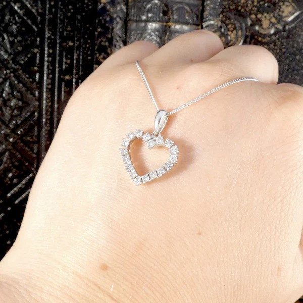 Diamond heart shaped pendant necklace in white gold.