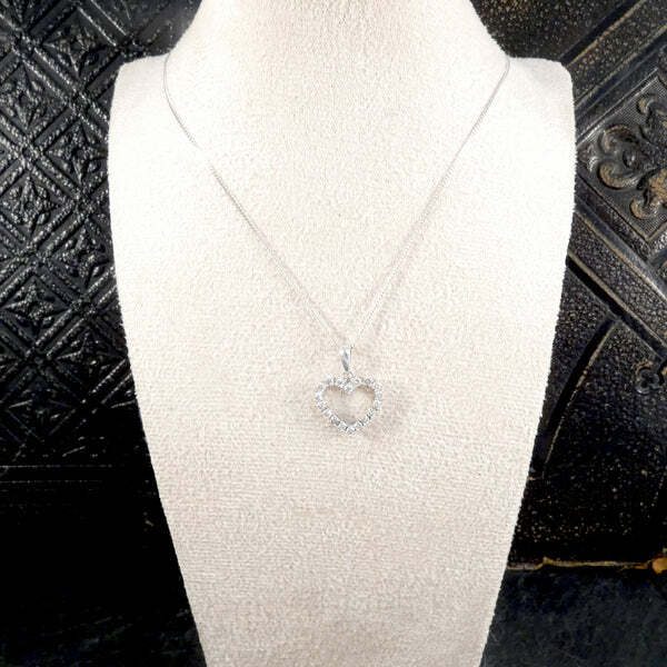 Diamond heart shaped pendant necklace in white gold.