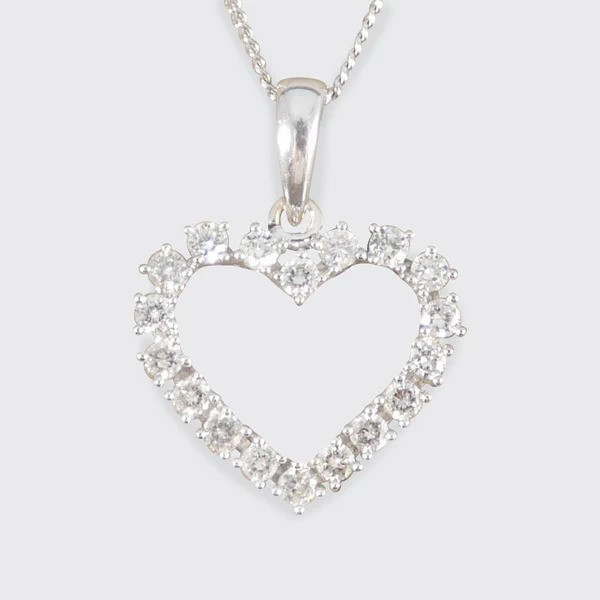 Diamond heart shaped pendant necklace in white gold.